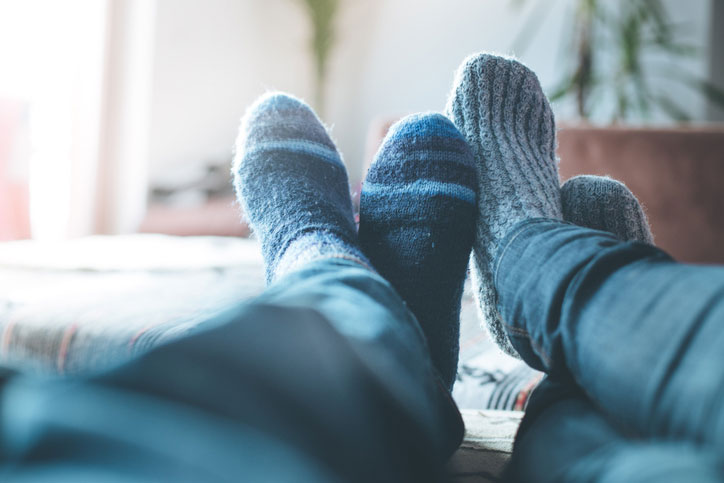 A couple's feet in socks