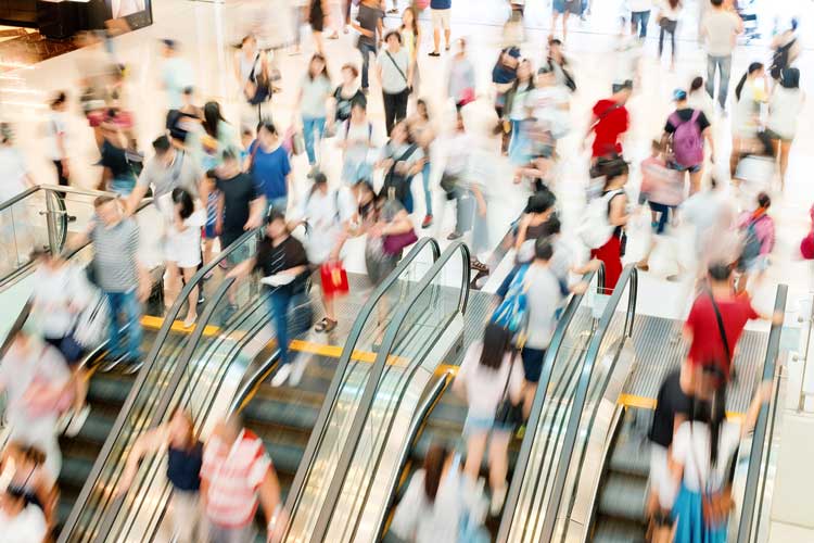 Shopping Mall Traffic on escalator, debt is not a dirty word